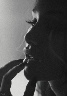 black and white photograph of a woman brushing her teeth