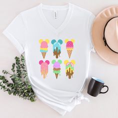 Bring some magic to your summer wardrobe with this enchanting ice cream tshirt! The colorful design features whimsical ice cream treats, perfect for any Orlando theme park vacation or family trip. Made with soft and breathable fabric, this v neck tshirt is both comfortable and stylish. Looking good on both men and women, this soft jersey tee is comfortable enough to wear all day long. High quality print will make it an instant favorite in every wardrobe. .: 100% Airlume combed and ring-spun cotton (fiber content may vary for different colors) .: Light fabric (4.2 oz/yd² (142 g/m .: Retail fit .: Tear away label .: Runs true to size Please be sure to double check color and sizing before ordering. To measure for size, it is easiest to take a shirt that you already own, and that fits you well Cute Multicolor T-shirt For Vacation, Trendy Multicolor T-shirt For Vacation, Summer Vacation Tops With Character Print, Trendy Multicolor Summer T-shirt, Novelty Cartoon Print Summer Tops, Summer Novelty Tops With Cartoon Print, Novelty Summer Tops With Cartoon Print, Summer Multicolor Character Print T-shirt, Novelty Character Print Tops For Summer