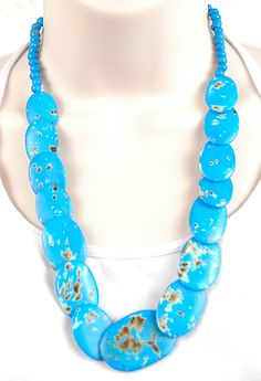 A turquoise colored necklace with polished discs of artificial bone. The blue color stained with olive adds to the overall bohemian look. Smaller beads round up on the string. A great accoutrement to go with one of our bohemian skirt or dress for that ravishing look. The necklace measures 24 inches. Bohemian Turquoise Necklace For Vacation, Blue Bohemian Wooden Beads Necklaces, Bohemian Turquoise Necklace With Large Beads For Beach, Bohemian Large Beaded Turquoise Necklace For Beach, Turquoise Necklaces With Wooden Beads For Beach, Turquoise Necklace With Wooden Beads For Beach, Blue Turquoise Necklace With Large Beads For Beach, Turquoise Necklace With Large Beads For Beach, Blue Bohemian Necklaces For Vacation