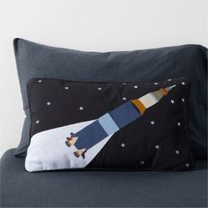 a pillow with an image of a rocket ship on it