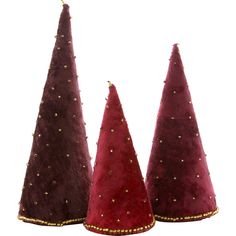 three small christmas trees with gold studdings on them are shown side by side