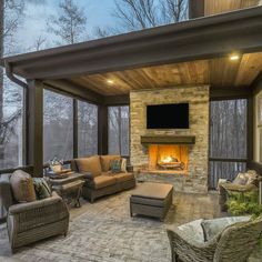 a covered patio with furniture and a fireplace