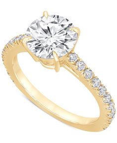 a yellow gold engagement ring with an oval cut diamond and side stones on the band