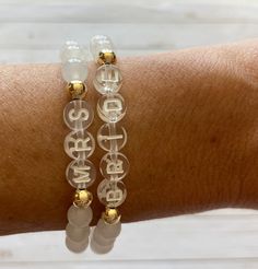 This is the perfect bride to be gift! This natural white jade bracelet is so beautiful with the gold beads + clear letter beads. Each bracelet will arrive individually packaged in an organza bag ready to gift! Bracelets have gold filled beads and won't tarnish. Gold filled is the best + most affordable option after real gold. Please check all selections and spelling prior to check out. Our custom bracelets are made to order so all sales are final. Receipts are never included in your package. If Adjustable White Bracelet For Anniversary, Dainty White Bracelets For Bridesmaid Gift, Adjustable White Bracelets For Wedding, White Dainty Beaded Bracelets For Bridesmaid Gift, Dainty White Beaded Bracelets For Bridesmaids, Dainty White Bracelets For Anniversary, Dainty White Bracelet For Anniversary, Dainty White Round Charm Bracelet, White Crystal Bangle Bracelet For Anniversary