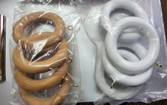 several different types of wooden rings in plastic bags