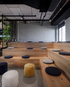 an empty room with benches and stools in it