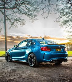 a blue car parked on the side of a road