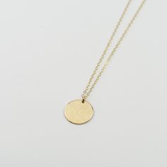 "14K solid gold coin necklace - Hammered disc necklace The perfect everyday, every occasion necklace. This necklace will dress up a casual blouse or look stunning with an evening dress. If you only had one necklace, this is the necklace you want. The necklace will arrive in a nice gift box, ready for delivery. 14K solid gold disc, it is 22 gauge (Please select the size of the disc, the model wears a 5/8\" disc necklace) 14K gold 1.5mm chain All components are 14k gold Please read our policies be Gold Heart Bracelet, Gold Slides, Gold Disc Necklace, Gold Coin Necklace, Gold Bead Necklace, Gold Disc, Crescent Moon Necklace, Hammered Gold, Toggle Bracelet