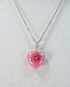 "Delicate Vintage Lampwork Pink Heart Pendant on Sterling 20 Inch Chain  Featured is a delicate, vintage glass lampwork pink heart pendant on a sterling silver chain. This beautiful little heart has a pink rose design created within the glass. The sterling silver 1mm bead chain, measures 20 inches and the pendant measures 5/8 by 7/8 inches. To appreciate this sweet piece, zoom in for details. I hope you've enjoyed looking at my creations. They are so much fun to create! All of my jewelry is crea Pink Rose Design Jewelry For Valentine's Day, Pink Pendant Keepsake Jewelry, Pink Heart Pendant Jewelry For Keepsake, Pink Heart Pendant Necklace For Jewelry Making, Pink Rose Pendant Jewelry, Elegant Pink Necklace For Keepsake, Pink Open Heart Necklace For Weddings, Elegant Pink Keepsake Necklace, Rose-colored Heart-shaped Jewelry For Gifts