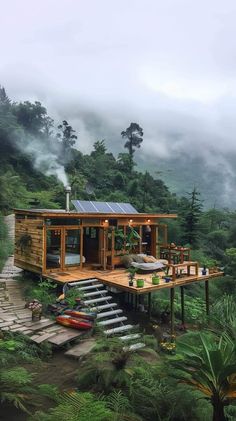 a small cabin in the middle of a forest with stairs leading up to it's roof