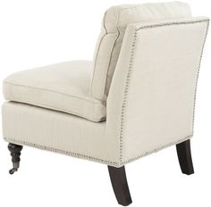 an upholstered chair with studded trimmings on the legs and back