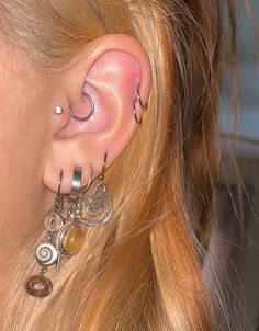 a close up of a person with ear piercings on their ears and behind the ear