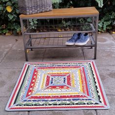 a pair of blue shoes sitting on top of a rug next to a metal shelf