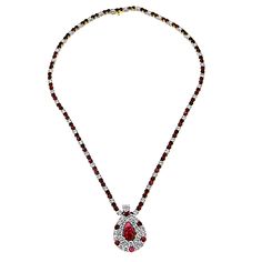 Presenting from our Vintage Estate Jewelry Collection: 18K White Gold Ladies Diamond and Ruby Necklace. A simple necklace can be a tasteful addition to any outfit, but sometimes simple is simply not enough. This ladies diamond and ruby necklace quite literally makes a splash with its flowing raindrop shape that seems to trickle down the neck. It cascades like a fountain of 6.5 carats of diamonds and rubies, while the 18k white gold with yellow gold accents gives it a fiery luminescence. This pie 18k Gold Necklace, Ruby Necklace, Stunning Jewellery, Diamond Watch, Simple Necklace, Not Enough, Estate Jewelry, Gold Accents, Custom Jewelry