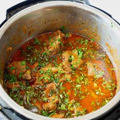 a pot filled with meat and vegetables on top of a stove