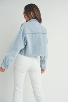 This cargo inspired denim jacket by Just Black is the perfect addition to your wardrobe. Made from lightweight cotton denim, this trendy jacket features an oversized boxy fit + a cropped length with raw hem detail. The large cargo chest pockets are right on trend + add a casual touch to this jacket. This will be an easy layering piece to throw on + go all season long. Fit: Oversized, boxy cut. Fabric: 100% Cotton Black Cargo Jacket, Maxi Jumpsuit, Kimono Sweater, Trendy Jackets, Cargo Jacket, Cropped Denim Jacket, Dress With Cardigan, Cropped Denim, Light Denim