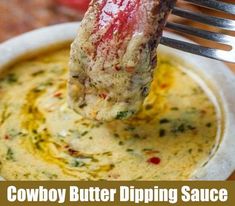 a piece of meat is being lifted from a bowl of soup with the words cowboy butter dipping sauce on it