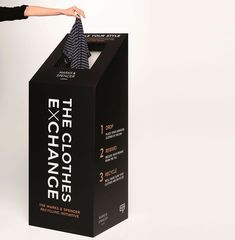 a woman opening up a black box that says the exchangeancee clothes on it