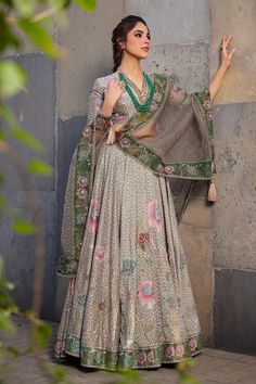 Dark green lehenga with an attached cancan, all-over floral prints, highlighted with pearls, glass beads and sequin embroidery. Comes with coordinating blouse and dupatta. - Aza Fashions Pista Green Silk Lehenga With Intricate Embroidery, Silk Lehenga With Meenakari For Designer Wear, Festive Brocade Lehenga With Mirror Work, Traditional Brocade Lehenga With Mirror Work, Silk Meenakari Choli For Reception, Wedding Lehenga With Mirror Work In Brocade, Pista Green Silk Unstitched Lehenga, Unstitched Pista Green Silk Lehenga, Green Brocade Choli With Dupatta