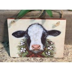 a cow painted on the side of a wooden box