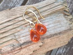 These beautiful little drop earrings are made with a smooth orange Czech glass teardrop. These are light and lovely earrings to wear every day, to dress up a casual outfit or for a special occasion. The drop beads are top quality czech glass, beautiful clear shade  and intens clarity of colour and glossy finish. Colour varies depending on the light conditions from light to dark. Teardrop size is 10 x 14 mm (approximately 1/2 inch). The whole length from the top of the ear hook is 30 mm (1,18 in) Orange Teardrop Earrings As Gift, Amber Teardrop Earrings Gift, Amber Teardrop Earrings As A Gift, Amber Teardrop Drop Earrings For Gift, Handmade Orange Teardrop Earrings For Gift, Orange Teardrop Jewelry With Matching Earrings, Handmade Orange Teardrop Earrings, Lilac Earrings, Earrings Classic