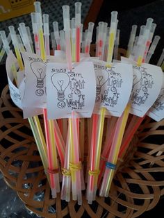 several different colored straws in a basket with some tags on them that say i love you