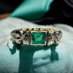 an antique ring with a green stone in the center