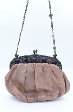 Beautiful vintage Jacomo of Paris lizard skin handbag with ornate sterling silver frame, bezel-set with genuine cabochon amethyst and acorn bypass clasp. Frame has a double-sided design. Amethyst on one side and cherubs with grapes on the other. The chain is a floral with laughing mask links attached to the purse with swan rings. Measures - 7 1/2 x 5 1/2 inches, 19.05 x 14 cm CONDITION: The leather has dried a bit, but is still in usable condition. The label came off, but is present. Lining is intact.  Comes with a tiny matching change purse. Laughing Mask, Lizard Skin, Top Handle Bags, Change Purse, Silver Frame, The Label, Purses And Handbags, Halloween Shopping, Top Handle