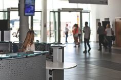 a woman is sitting at the counter in an airport