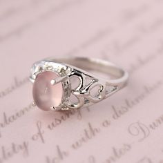 Presenting you A Beautiful Rose Quartz Ring In Filigree  Style Shank Ring with Oval Cabochon Rose Quartz . The color of the cabochon used is really soothing to the eyes. Perfect Gift For Her or as a proposal Ring or you can gift yourself Item No: skj.18.501 Item: Pink Quartz Ring in 925 Sterling Silver Primary Stone: Pink Quartz Secondary Stone:-- Article Weight: 5.1 gms primary stone Size: 9x7  mm Ring Length: 2.1 cm Ring Width: 1.1 cm Maintenance Tips 1. Keep the jewelry away from direct heat, water, perfumes, deodorants, and other strong chemicals.  2. Wipe the Jewellery gently with a chamois cloth or leather swatch after every use.  3. Wiping the jewelry with a soft cloth after removing the jewelry would a PAYMENT POLICY  PAYMENT THROUGH PAYPAL ONLY. SHIPPING POLICY Processing time for Sterling Silver Oval Rings For Valentine's Day, Pink Oval Moonstone Ring In Sterling Silver, Rose Gold Oval Moonstone Ring, Oval Rose Gold Moonstone Ring, Pink Oval Cabochon Wedding Ring, Silver Oval Rings For Valentine's Day, Elegant Oval Rose Quartz Rings, Pink Quartz Jewelry, Ring Rose Quartz