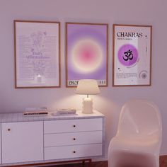 a white chair sitting next to a table with a lamp on it in front of two posters