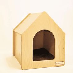 a small wooden dog house with the door open