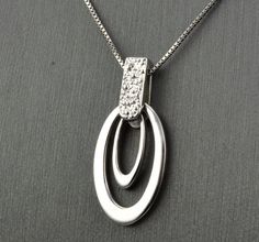 "14 KARAT WHITE GOLD MODERN PENDANT WITH HIGH POLISH . AVAILABLE SAME STYLE EARRINGS metal-14kwg weight-3.4gm FOR ADDITIONAL QUESTIONS ABOUT THIS PRODUCT: Please feel free to message us. We are quick to respond to all your inquiries. PLEASE choose as \"FAVORITE\" on the right so the item will be added to your favorites list and you may always revisit it. CUSTOM ORDERS: Please feel free to contact us if you could not find the piece you had in mind. We know how important it is to find the right je Modern Diamond Cut Necklace, Modern Diamond White Pendant Necklace, Modern Diamond White Pendant Necklaces, Modern Diamond Cut Pendant Necklace, White Gold Diamond Cut Necklace With Oval Pendant, Modern Formal Pendant Diamond Necklace, Modern White Gold Necklace With Diamond Accents, Modern White Gold Diamond Necklace With Polished Finish, Modern Silver Diamond Necklace