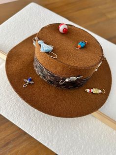 a brown hat sitting on top of a wooden table