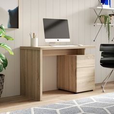 an office desk with a computer on it and a chair in front of the desk