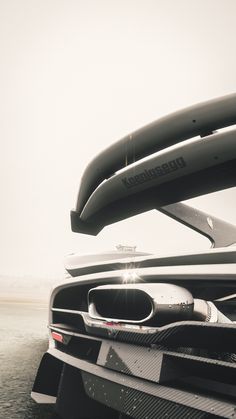 the front end of a sports car with its hood open