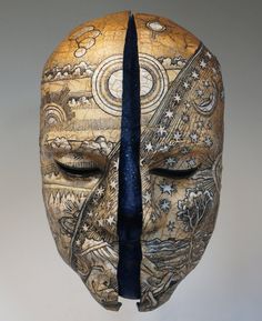 a wooden mask with an intricate design on it