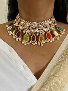 Be your own kind of beautiful. Simply a mark of royalty and elegance! You will definitely fall in love with the beautifully placed carved multi coloured stones with Kundan Stone embellishments. One of our favorite picks for the wedding season ❤️ The pretty statement earrings add to the royalty of the stunning choker necklace. Notice the CZ stones bordering the carved stones  Length of earrings: 7 cms  Width of earrings: 5 cms, push back closure Weight of earrings: 38 grams ( pair) The necklace c Festive Wedding Jewelry With Gemstone Accents, Traditional Jewelry With Gemstone Accents For Party, Fusion Style Jewelry With Gemstone Accents For Celebration, Traditional Festive Jewelry With Gemstone Accents, Fusion Jewelry With Gemstone Accents For Celebration, Elegant Multicolor Kundan Necklace, Multicolor Jeweled Earrings For Wedding, Elegant Multicolor Meenakari Necklace, Festive Multicolor Multi-stone Bridal Necklace