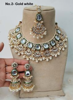 *Light Weight Kundan necklace set with earrings and tikka. *Studded with kundan stone. *Light Weight Gold kundan necklace. *Necklace width- 2.2 inches (included pearl drop) *Earrings Length- 3.3 inches(included pearl drop) *Earrings Dome Size- 1.1 inches Traditional Pista Green Jewelry For Wedding, Pista Green Jewelry For Festive Wedding, White Kundan Jewelry Sets With Hand Set Details, White Kundan Jewelry With Intricate Design, White Kundan Bollywood Jewelry, Bollywood Style Kundan White Jewelry, White Kundan Jewelry With Stone Work, White Kundan Chandbali Jewelry, White Chandbali Kundan Necklace Hand Set