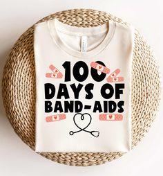 a t - shirt that says 100 days of band aids on it next to a wicker basket