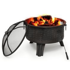 an outdoor fire pit with flames coming out of the top, and mesh netting around it