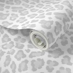 a white and grey wallpaper with an animal print pattern on the bottom half of it