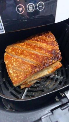 a grilled sandwich is being cooked in an air fryer