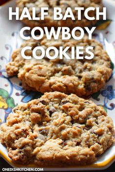 two cookies on a plate with the words half batch cowboy cookies above it and an image of