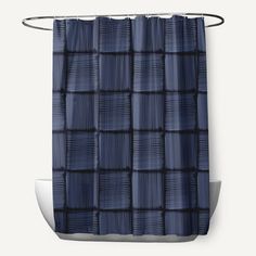 a blue shower curtain with black squares on the bottom, and an attached metal hook