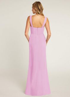 a woman in a pink dress looking back