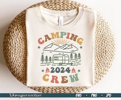 a t - shirt that says camping crew on it next to a wicker basket