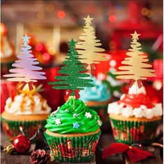 cupcakes decorated with christmas trees and decorations