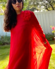 "Chiffon for days! This 60s I. Magnin red gown is a real stunner. Long sheer sleeves, layers of chiffon, huge sweep with the sweetest corsage at the shoulder. Back zipper closure, with snaps to close the top layer. Excellent vintage condition. Has a few spots at the back of the hemline. Dried cleaned. No size tag or fabric tag. Laid flat: 15\" Shoulder to shoulder  21\" pit to pit  20\" Waist  22\" Hips  56\" Long  24\" sleeves" Red Floor-length Gown For Wedding Guest, Red Chiffon Party Gown, Red Long Sleeve Organza Dress, Long Sleeve Silk Chiffon Dress For Party, Silk Chiffon Long Sleeve Dress For Parties, Red Georgette Evening Dress, Red Georgette Evening Gown, Red Chiffon, Maxi Gown