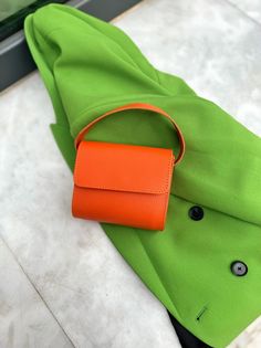 My New Top Handle Bag that is made from Full Grain Leather in Orange color is my latest creation for Summer 2022. The ''Petite Aux Yeux'' is a really one of a kind bag, in rectangular shape  with a spacious single interior section and a modern design. Find them only at Christina Christi Store. 👉 My Women Leather Handbags Collection: https://etsy.me/2kJH9gZ 👉 Express Shipping: https://etsy.me/3ikUnOM MATERIAL - Real Genuine Leather from Cow. - Magnetic Clasp. - Metal Buckles. - Single Part at t Trendy Top Handle Pouch For Gift, Trendy Top Handle Pouch As Gift, Modern Orange Crossbody Bag, Trendy Pouch Flap Bag With Top Carry Handle, Gift Pouch Box Bag With Adjustable Strap, Trendy Pouch Baguette Bag As Gift, Trendy Baguette Pouch Bag As Gift, Trendy Orange Box Bag For Travel, Orange Shoulder Box Bag For Travel